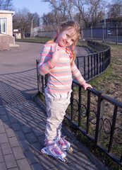 On a warm spring evening, a girl is skating on roller skates.