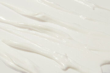 Thick white cosmetic cream applied to the surface. texture of the cream close-up.