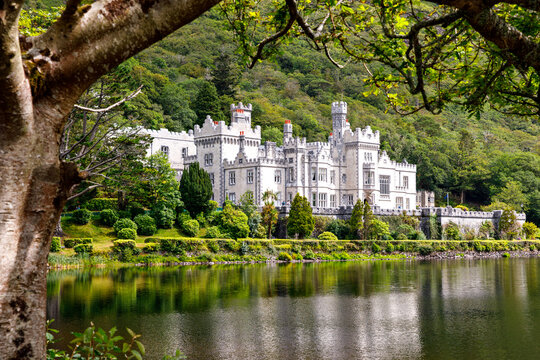 Kylemore Abbey with water reflections in Connemara, County Galway, Ireland, Europe. Benedictine monastery founded 1920 on the grounds of Kylemore Castle. Mainistir na Coille Moire - Powered by Adobe