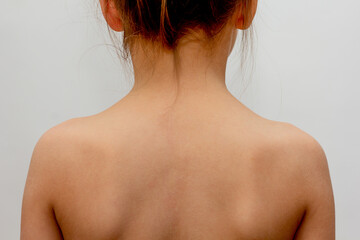 Rear view of child with normal spine on white background - obrazy, fototapety, plakaty