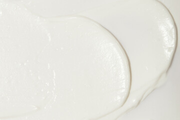 Thick white cosmetic cream applied to the surface. texture of the cream close-up.