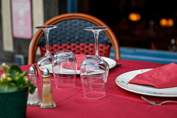 Empty glasses set in restaurant - Dinner table outdoors in France.