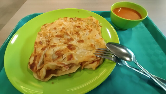Indian roti prata breakfast with curry sauce