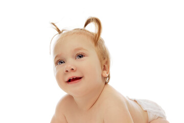 Portrait of happy little baby girl, toddlers with two ponytails sitting in diaper with playful happy face isolated on white background. Concept of childhood, care, health, well-being, parenthood