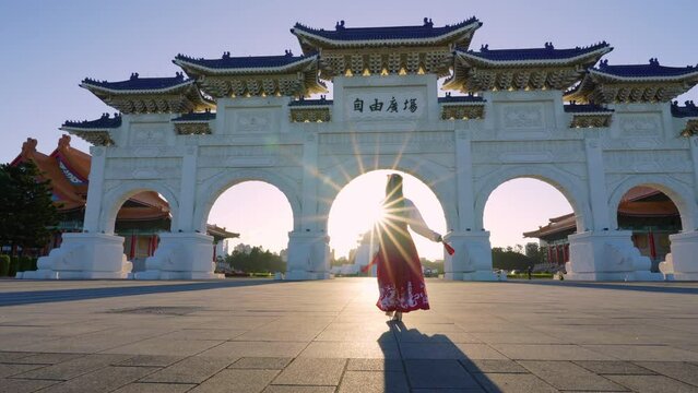 Slow motion video. Chiang Kai  Shek Memorial Arch with morning sunlight and Asian women in Taipei, Taiwan.