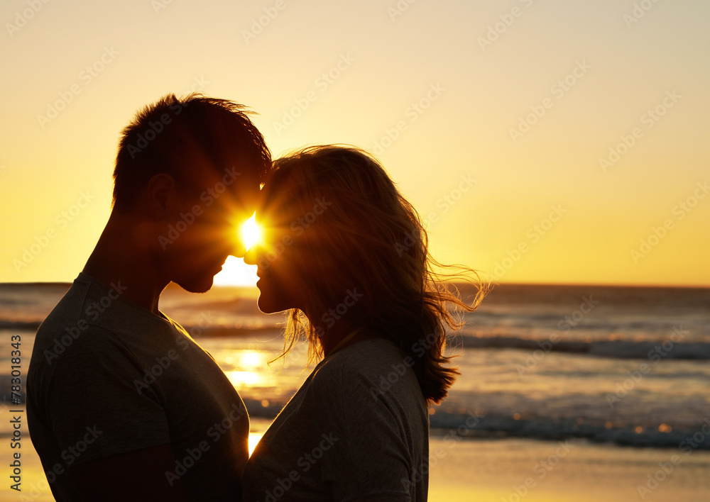 Poster Couple, romance and kiss at beach with sunset for date or summer holiday and bonding in Florida. Relationship, commitment and love together as soulmate with smile or happy for honeymoon and vacation