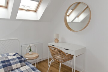 attic room in white colors: mirror, table, chair, bed