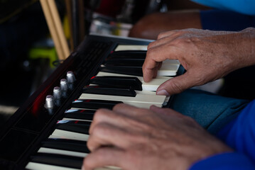 Detail of a hand playing the keyboard at an event.