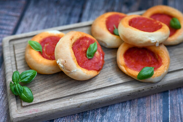 Mini margherita napoletan pizza with tomato,mozzarella  cheese and basil,  on wooden background