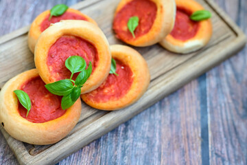 Mini margherita napoletan pizza with tomato,mozzarella  cheese and basil,  on wooden background