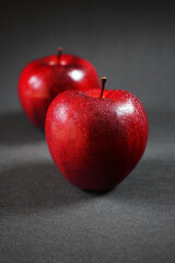 Ripe red apples closeup on a dark background