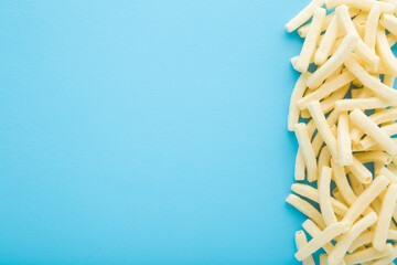 White potato chips sticks on light blue table background. Pastel color. Closeup. Empty place for text. Top down view. - 783033135