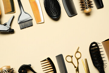 Hairdressing tools on beige background, flat lay. Space for text