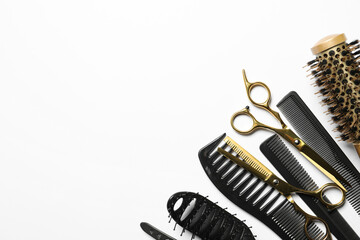 Fototapeta na wymiar Hairdressing tools on white background, flat lay. Space for text