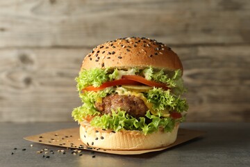 Burger with delicious patty on gray table