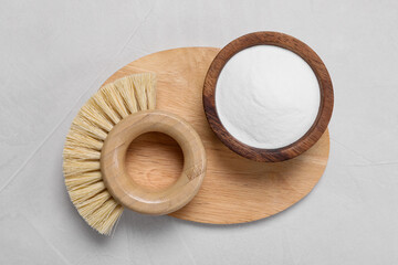 Cleaning brushes and baking soda on white table, top view