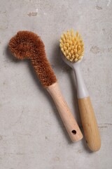 Cleaning brushes on light grey table, top view