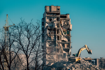 construction equipment destroys houses damaged during the war in Ukraine