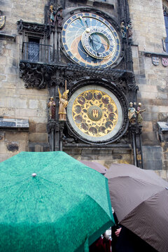 A beautiful image of the historic astronomical clock of Prague, the rain adding depth to the age-old timepiece, a blend of art and science