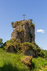 Craggy hill spur Bergschmidtsknock with summit cross at ruin of Bärnfels Castle near Obertrubach...
