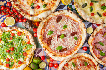 Colorfully decorated table with pizzas: A vibrant spread featuring an assortment of pizzas adorned with a variety of colorful and flavorful toppings, creating an inviting and appetizing display.