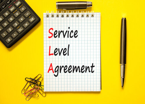 SLA service level agreement symbol. Concept words SLA service level agreement on beautiful white note. Beautiful yellow background. Business SLA service level agreement concept. Copy space.