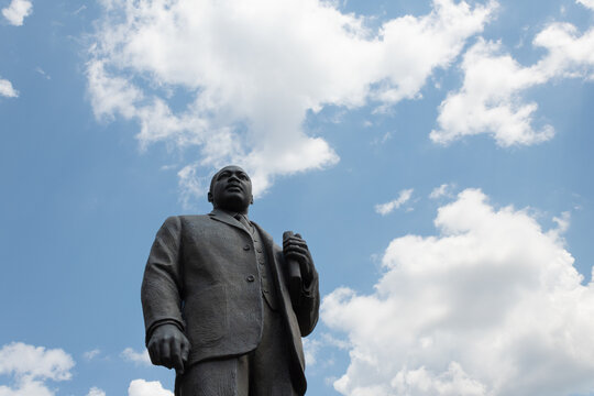 Birmingham Alabama, USA - May 16, 2019 Wide view looking up at bronze statue of Martin Luther King Jr in Kelly Ingram Park