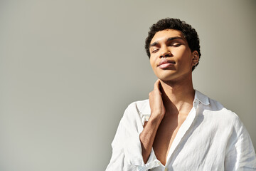 alluring african american male model in linen sophisticated attire posing on beige backdrop