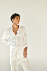 alluring elegant african american man in chic linen clothing looking away on beige backdrop