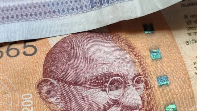 Indian rupee (INR) and United Arab Emirates dirham (AED) national currency note extreme closeup macro top view. India and UAE international trade, business relation, cooperation and commerce concept.