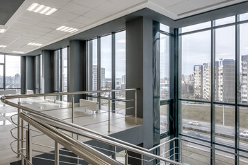 panorama view in empty modern hall with columns, doors, stairs and panoramic windows - 783063332