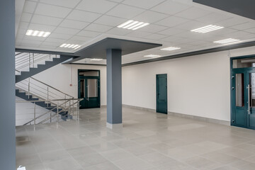 panorama view in empty modern hall with columns, doors, stairs and panoramic windows - 783063335