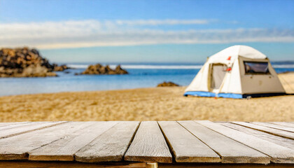 Wooden table in the blurred camping tent on the beach on a beautiful sunny day.Summer vacation, outdoor lifestyle. Cool and relaxing concept. For product display montage or key visual layout design. s