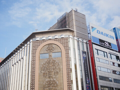 TOKYO, JAPAN - February 1, 2024: Front of Mitsukoshi Department Store in Ginza with a Daikin sign displaying humidity on the top of an adjacent building.