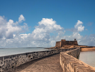 Fototapeta na wymiar Stunning sea front of the old town of Arrecife, with the ruins of the old castle of San Gabriel in the background, Lanzarote, Canary Islands, Spain