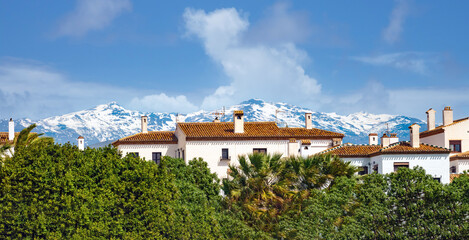 Lush subtropical vegetation, moorsih architecture and snow capped mountains, Motril, Andalusia, Spain