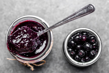 Aronia jam and fresh berry on stone table. - 783082535