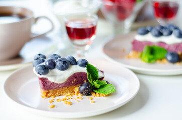 The baked vanilla and berries flavour cheesecake swirled with blueberry sauce on a digestive biscuit crumb - 783089162