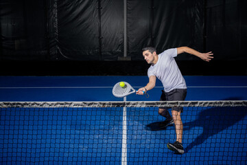 Padel player hitting ball with a racket