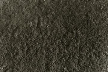 A black and white photo of a rocky surface. The photo is grainy and has a rough texture
