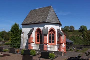 Gothic chapel with pointed apse windows in the old village cemetery of Duppach, Eifel region in...
