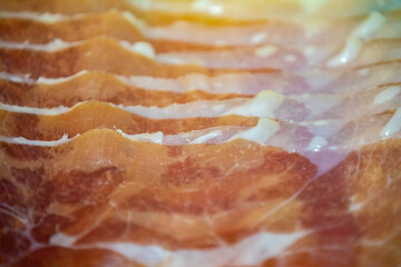 sliced parma ham in selective focus and fine details