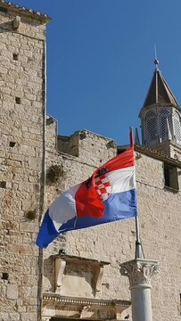 Croatian flag fluttering on a flagpole, Trogir, Croatia. Vertical Video