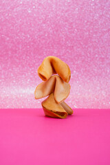 Fortune cookies are stacked on top of each other on a pink background - 783101766