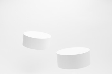 Set of two round tilt white podiums for cosmetic products mockup, soar on white background. Stage for presentation skin care products, gifts, goods, advertising, design, sale in contemporary style. - 783107351
