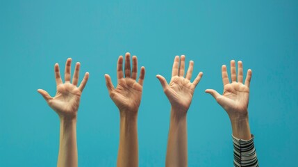 Hands of young people raised up on a blue background - obrazy, fototapety, plakaty