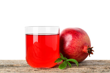 Refreshing pomegranate juice in glass, leaves and fruit on wooden table against white background