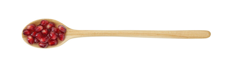 Ripe juicy pomegranate grains in wooden spoon isolated on white, top view