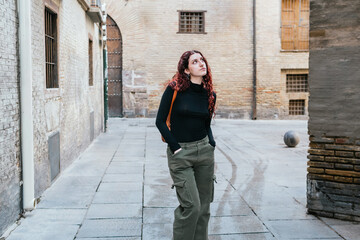 Tourist walking through the historic center of Zaragoza, Spain, observing the buildings and monuments he passes by