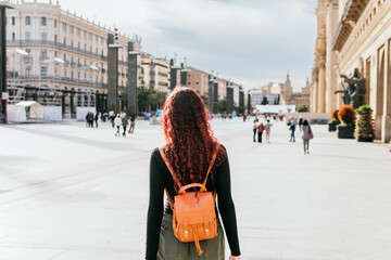 Tourist unrecognizable walking through the Plaza del Pilar in the city of Zaragoza, Spain